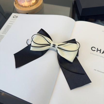 CHANEL 26S BOW HAIR CLIP IN BLACK AND WHITE SATIN 503132
