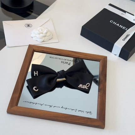 CHANEL 26S BOW HAIR CLIP IN BLACK SATIN 503134