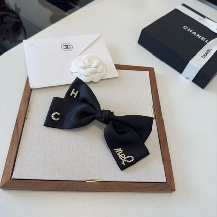 CHANEL 26S BOW HAIR CLIP IN BLACK SATIN 503134