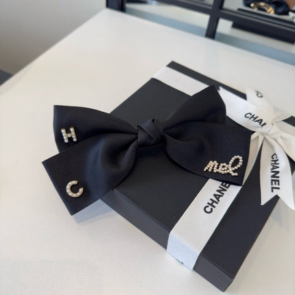 CHANEL 26S BOW HAIR CLIP IN BLACK SATIN 503134