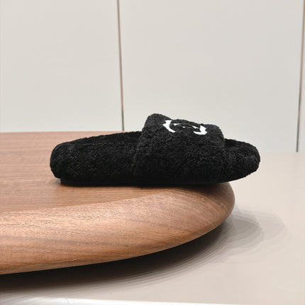 CHANEL 26S SLIDE MULES IN BLACK SHEARLING AND WHITE CC LOGO