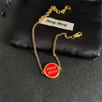 MIUMIU 26S LOGO ROUND BRACELET IN RED ENAMEL AND GOLD TONE METAL 631810