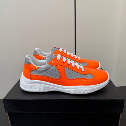 PRADA 26S SNEAKERS IN ORANGE PATENT CALFSKIN AND WHITE MESH